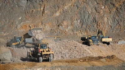 Wheel loaders fill trucks with ore at the MP Materials rare earth mine in Mountain Pass, California, USA, on January 30, 2020. (Photo: Steve Marcus/Reuters)