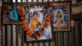 A portrait of Dipu Chandra Das, a Hindu man who was beaten to death by a mob, hangs alongside images of Hindu deities inside his home in Tarakanda village, Mymensingh District, Bangladesh, on January 9, 2026. (Photo: Mahmud Hossain Opu/AP)
