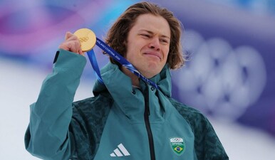 Gold medallist Lucas Pinheiro Braathen of Brazil celebrates on the podium. Image: Reuters