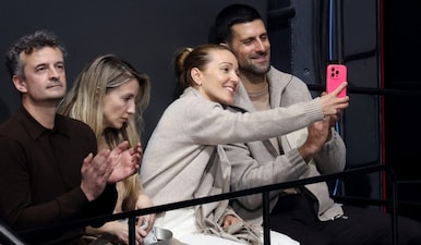 Novak Djokovic has a selfie with a fan in the stands before the start of the men's single free skating at the Winter Olympics. Reuters