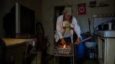 Minorkys Hoyos Ruiz lights coals to cook dinner during a scheduled blackout to ration energy in Santa Cruz del Norte, home to one of Cuba’s largest thermoelectric plants, late afternoon Tuesday, Feb. 3, 2026. (AP Photo/Ramon Espinosa)
