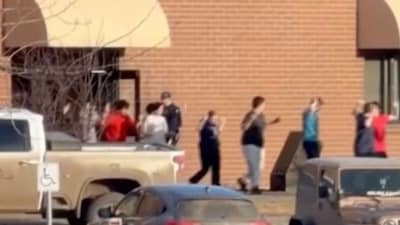 Students exiting the Tumbler Ridge school after the deadly shooting (AP)