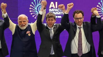 Prime Minister Narendra Modi (L) takes a group photo with AI company leaders including OpenAI CEO Sam Altman (C) and Anthropic CEO Dario Amodei (R) at the AI Impact Summit in New Delhi on February 19, 2026. AFP