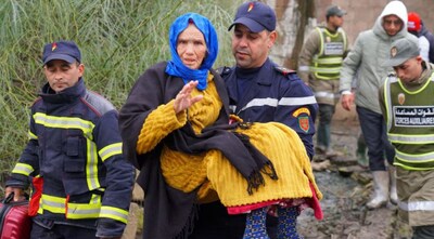  A man carries a woman as local authorities in the Ksar El Kebir province continue emergency operations, after heavy rainfall raised water levels in the region, disrupting traffic on multiple roads, in Ksar El Kebir, Morocco January 30, 2026. Image Credit: REUTERS