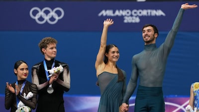 USA's Madison Chock and Evan Bates look on as France's Laurence Fournier Beaudry and Guillaume Cizeron celebrate their victory in the ice dancing free skate in figure skating at the 2026 Winter Olympics. AP