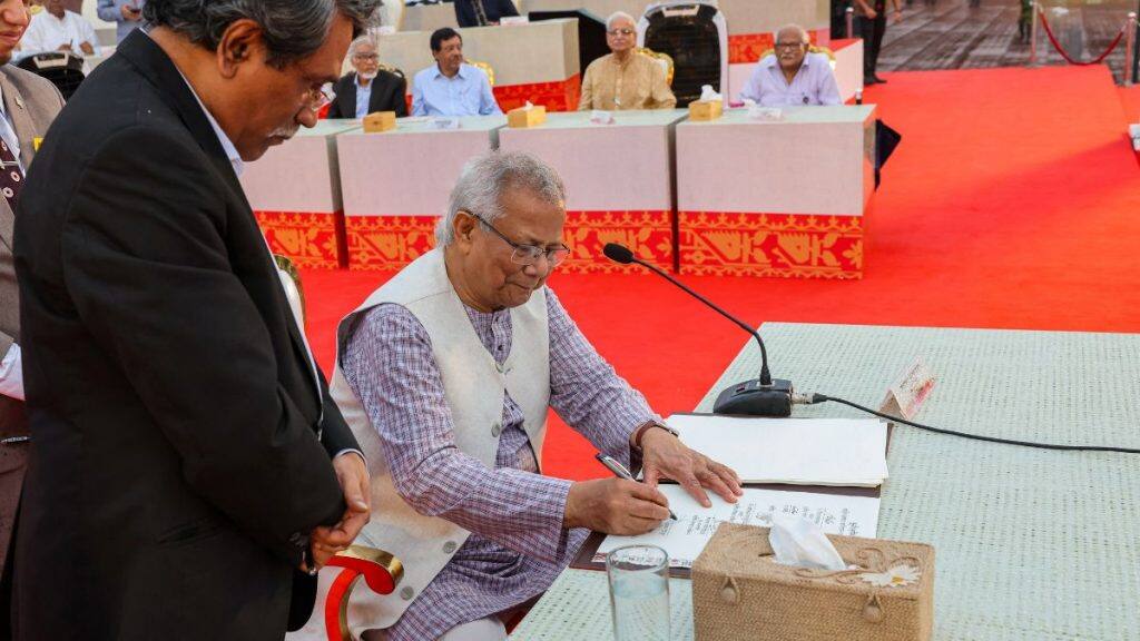 Muhammad Yunus, head of Bangladesh’s interim government, signs the July Charter during a ceremony at the National Parliament in Dhaka, Bangladesh, October 17, 2025. File Image/Bangladesh Chief Adviser’s Press Wing