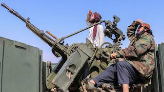 Taliban soldiers sit next to an anti-aircraft gun while on lookout for Pakistan's fighter jets, in Khost province, Afghanistan, on February 27. The two sides are firing deadly shelling and mortar fire across the border. Reuters 