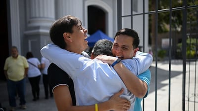 Human rights activist Javier Tarazona (R) is greeted by his brother Jose Rafael Tarazona (L) and lawyer Omar de Dios Garcia after his release from prison at La Candelaria church in Caracas on February 1. (AFP)