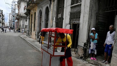 People queue at a street cart in Havana, as Cubans across the country slip into survival mode, enduring relentless blackouts and steep rises in the cost of food, fuel, and transport. (Reuters)