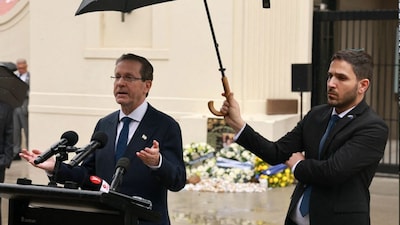 Israeli President Isaac Herzog (L) speaks after laying a wreath for victims of the December 14, 2025 gun attack at the Bondi Pavilion, in Sydney, on February 9, 2026. (AFP)