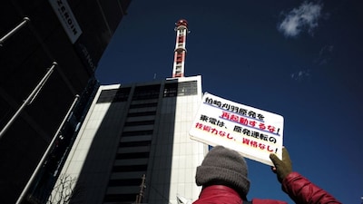A participant holds a placard that reads, "Do not restart the Kashiwazaki-Kariwa nuclear power plant!" (AFP)