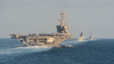 The USS Abraham Lincoln aircraft carrier transits the Strait of Hormuz. On Tuesday, the US military shot down an Iranian drone that was approaching the carrier. File image/AFP