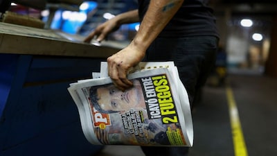A printing worker holds a freshly printed copy of the newspaper PM bearing the headline "US mapped ‘El Mencho’ and Mexico delivered the final blow, Caught between two fires," following the killing of drug lord Nemesio Oseguera, known as 'El Mencho,' in a military operation on Sunday, in Ciudad Juarez, Mexico. Reuters