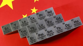 Blocks with symbols and atomic numbers of Rare Earth Elements (REE) are placed on a Chinese flag in this illustration taken January 21, 2026. Reuters