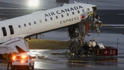 Debris hangs from a damaged Air Canada Express jet that had collided with a ground vehicle at New York's LaGuardia Airport in Queens, New York, US, March 23, 2026.  Reuters