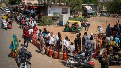 People stand in a queue with their empty LPG cylinders outside a gas agency amid supply disruptions following the US-Israeli conflict with Iran, in Ahmedabad, March 12, 2026.  Reuters