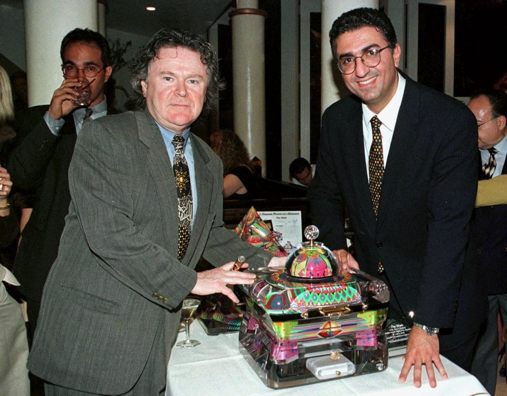 His Imperial Majesty Reza Pahlavi, son of the late Shah of Iran (R) poses with Yankel Ginzburg, designer of a special cigar humidor (shown C) commissioned by Pahlavi, at a reception celebrating Daily Variety's first cigar special issue April 28, 1997 in Beverly Hills, US. File Image/Reuters