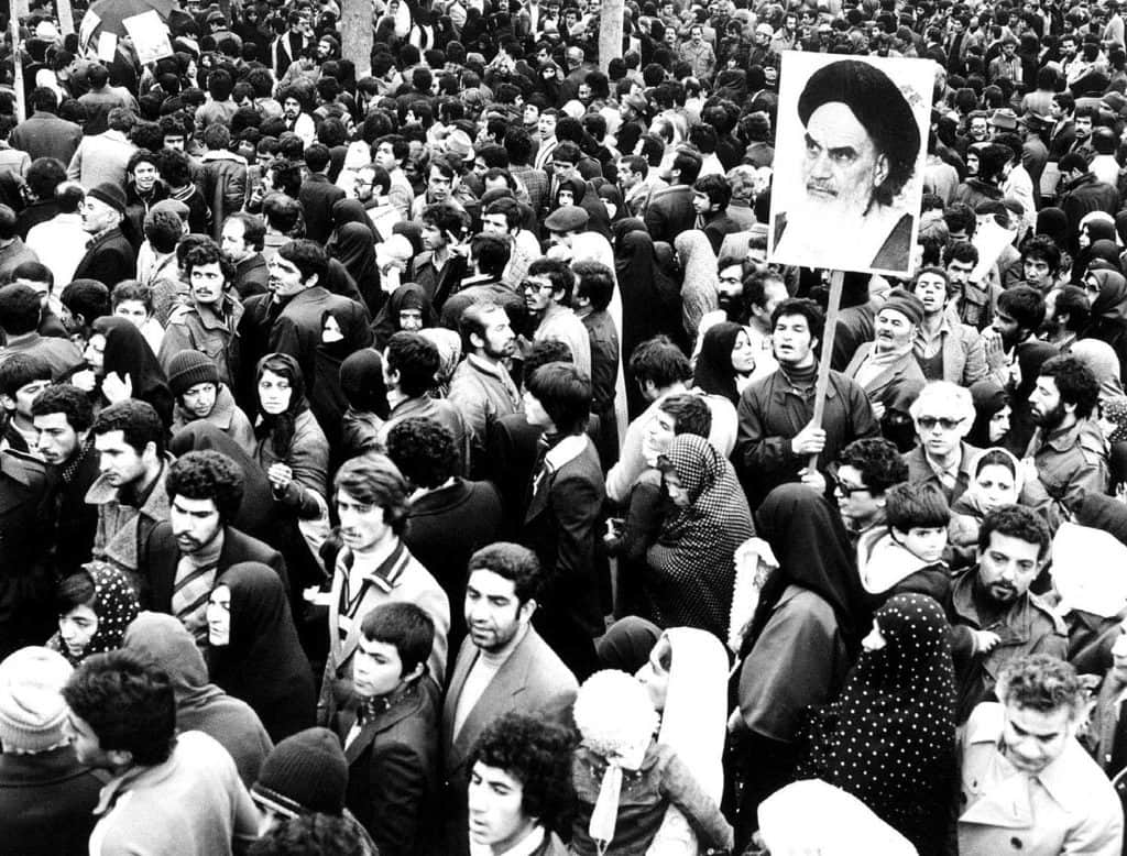 Supporters of the leader and founder of the Islamic revolution Ayatollah Khomeini hold his picture in Tehran during the country's revolution in February 1979. File Image/Reuters
