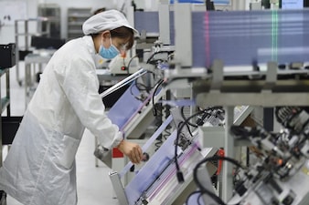 An employee works on the production line of a semiconductor chip company in Suqian, Jiangsu province, China February 28, 2023. China Daily via REUTERS