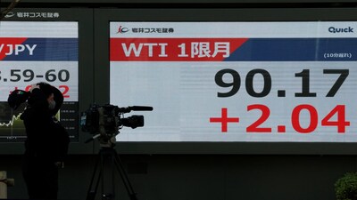 A TV cameraman films a stock quotation board showing the WTI 1-month futures outside a brokerage in Tokyo, Japan, March 24, 2026. Reuters
