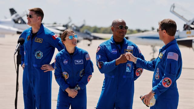 Nasa astronauts Reid Wiseman and Victor Glover greet each other next to Nasa astronaut Christina Koch and CSA (Canadian Space Agency) astronaut Jeremy Hansen, at Kennedy Space Centre, ahead of the Artemis II launch, Reuters