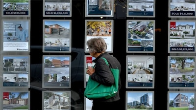A woman inspects listings at a real estate agency in Melbourne. (File/AFP)