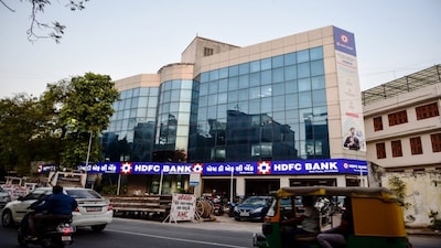 Vehicles drive past a branch of Housing Development Finance Corporation (HDFC) bank in Ahmedabad. (File/AFP)
