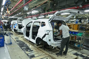 An employee works in a car assembly line at the joint manufacturing facility of Renault Nissan Automotive India, in Oragadam, an industrial suburb of Chennai. (Photo by AFP)