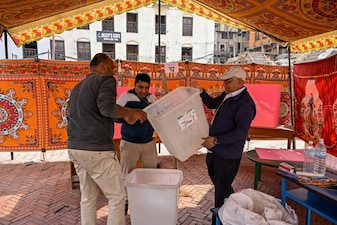 Polling officials check ballot boxes as they prepare a booth on the eve of Nepals parliamentary elections in Kathmandu on March 4, 2026. (Photo by Prakash MATHEMA / AFP)