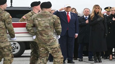 US President Donald Trump salutes as special envoy Steve Witkoff, First Lady Melania Trump and Attorney General Pam Bondi put hands on their heart while members of a US Army team carry a flagged-drapped transfer case containing the remains of Sgt. 1st Class Noah L. Tietjens during a dignified transfer solemn event at Dover Air Force Base, in Dover, Delaware, on March 7, 2026. AFP