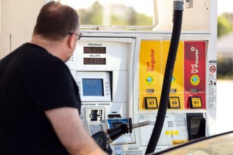 A man pumps gasoline into his vehicle at a gas station in Los Angeles, California. File image/AFP