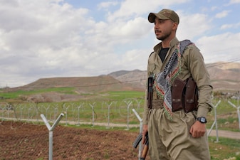 Member of the Democratic Party of Iranian Kurdistan PDKI stands at a checkpoint leading to their base in Koya district of Irbil, Iraq. AP