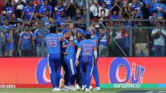 Members of the Indian cricket team rush to congratulate Axar Patel for completing a blinder of a catch to dismiss England captain Harry Brook during the T20 World Cup semi-final at Mumbai's Wankhede Stadium. Reuters