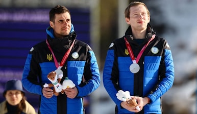 Maksym Murashkovskyi and his guide Vitaliy Trush celebrate on the podium. Image: Reuters