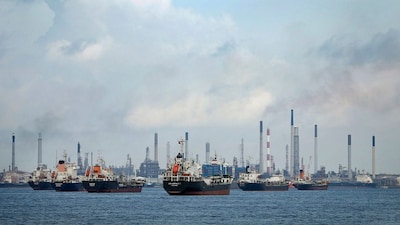 Ships are seen anchored in front of a refinery on Singapore's Bukom Island, July 6, 2014. About a quarter of the world's seaborne oil trade passes through the Malacca Strait, a choke point on the route between West Asia and the energy-hungry economies of East Asia. Representational image/Reuters