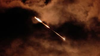 Streaks of light illuminate the sky during an interception attempt, amid the U.S.-Israeli conflict with Iran, as seen from Ashkelon, Israel, March 28, 2026. REUTERS

