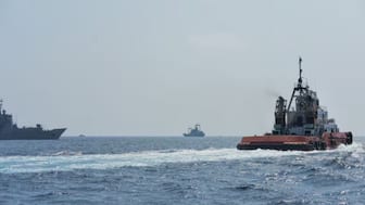 A Sri Lankan Navy tug boat and naval vessels approach an Iranian vessel during a rescue operation, a day after the crew of a distressed Iranian military ship, IRIS Dena were assisted in waters south of Sri Lanka, off the coast of Colombo, Sri Lanka March 5, 2026. Sri Lanka Navy/Handout via REUTERS