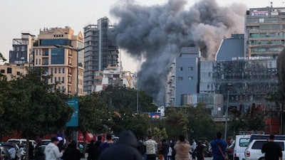 Smoke rises after an Israeli strike, as people gather after an evacuation order in Beirut, March 12. REUTERS
