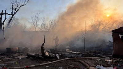 Ukrainian rescuers work to extinguish a fire at the site of an air attack in Zaporizhzhia on March 14, 2026, amid the Russian invasion of Ukraine. (Photo - AFP)