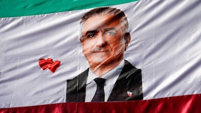 A flag with a picture of Reza Pahlavi, the exiled son of Iran's last shah and an Iranian opposition figure, is displayed during a protest of the Iranian diaspora following strikes by the US and Israel against Iran, in Madrid, Spain, February 28. Reuters