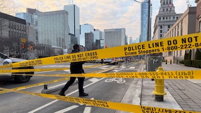A member of law enforcement personnel works at the scene outside the US Consulate after shots were fired, in Toronto, Ontario, Canada, on Tuesday. Reuters