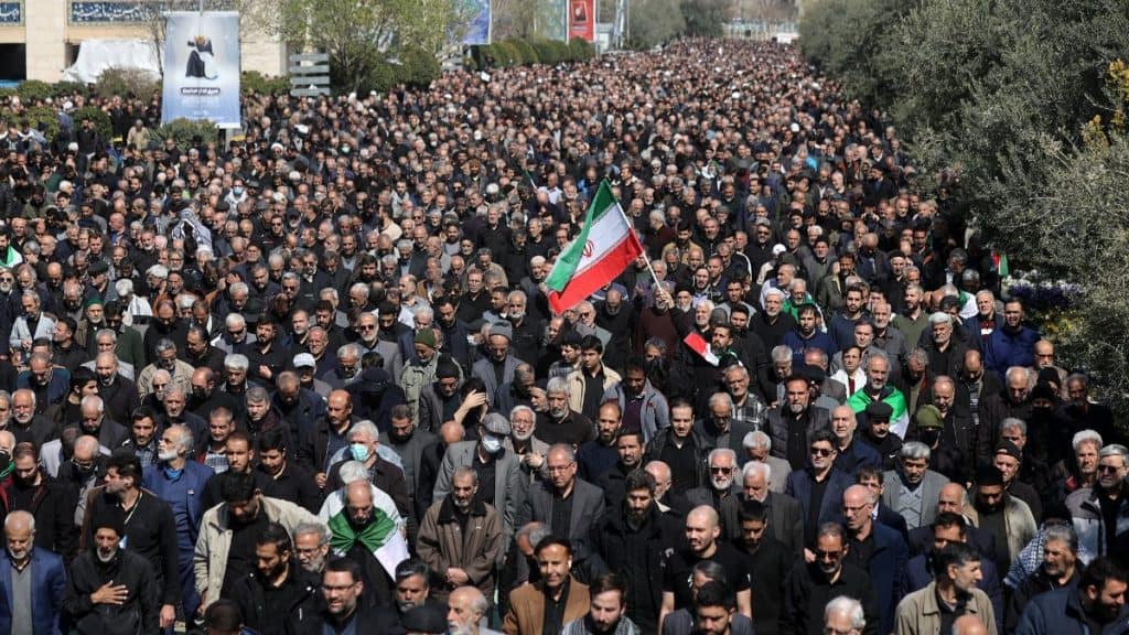A man waves an Iranian flag, as Muslims attend Friday prayer, amid the US-Israeli conflict with Iran, in Tehran, Iran, March 6, 2026. File Image/WANA via Reuters