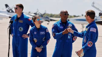 Nasa astronauts Reid Wiseman and Victor Glover greet each other next to Nasa astronaut Christina Koch and CSA (Canadian Space Agency) astronaut Jeremy Hansen, at Kennedy Space Centre, ahead of the Artemis II launch in Cape Canaveral, Florida, US, March 27, 2026. Reuters