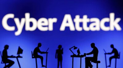 Figurines with computers and smartphones are seen in front of the words "Cyber Attack" in this illustration taken, February 19, 2024. REUTERS
