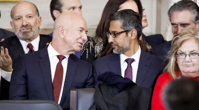 Businessman Jeff Bezos (L) talks with Sundar Pichai (R) at Donald Trump’s inauguration as the next President of the United States in the rotunda of the United States Capitol in Washington, DC, USA, 20 January 2025.  Image Credit: Reuters 