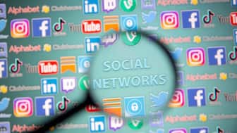 Social network words and social media logos are seen through magnifier displayed in this illustration taken, May 25, 2021. REUTERS