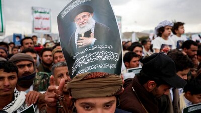 A protester with a poster on his head featuring a picture of late Iran's Supreme Leader Ayatollah Ali Khamenei joins a demonstration with Houthi supporters in solidarity with Iran and Lebanon, amid the US-Israeli conflict with Iran, in Sanaa, Yemen, March 6, 2026. File Image/Reuters