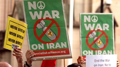 Members of the Iranian community hold placards during a rally in Sydney on March 1, 2026. (AFP)