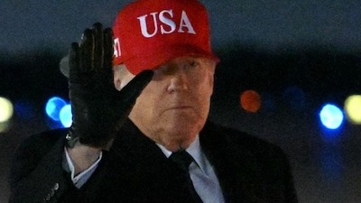 US President Donald Trump gestures after stepping off Air Force One upon arrival at Joint Base Andrews on March 1, 2026, (AFP)