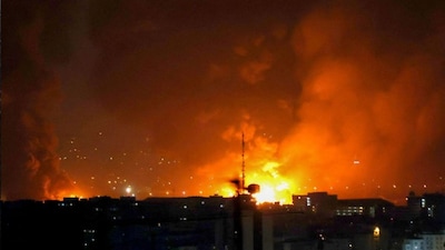 Smoke and fire rise from the site of airstrikes at Mehrabad International Airport in Tehran on March 7, 2026.
